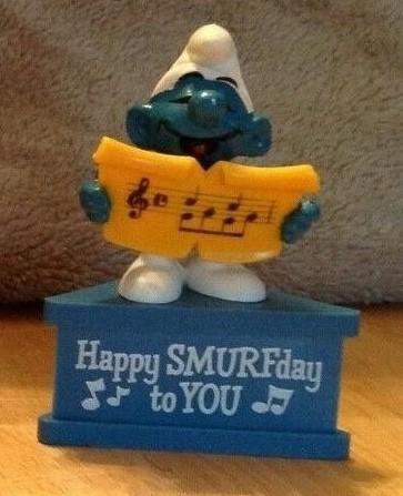 Schtroumpf chanteur avec partition