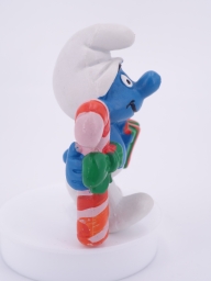 Schtroumpf de Noël avec cadeau et sucre d'orge - photo