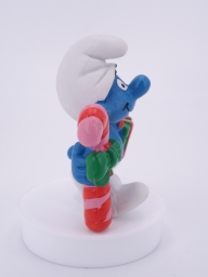 Schtroumpf de Noël avec cadeau et sucre d'orge - photo