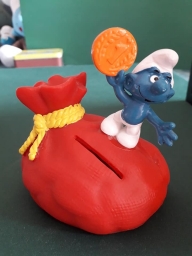 Tirelire Schtroumpf avec pièce et bourse