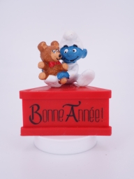 Bébé Schtroumpf avec ourson en peluche