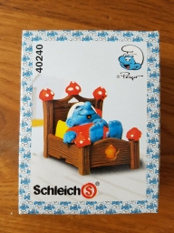 Schtroumpf dormeur dans son lit